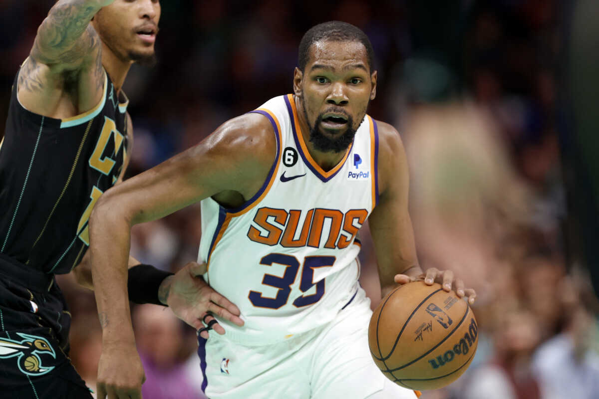 Mar 1, 2023; Charlotte, North Carolina, USA; Phoenix Suns forward Kevin Durant (35) drives to the basket past Charlotte Hornets guard Kelly Oubre Jr. (12) during the second half at Spectrum Center. Mandatory Credit: Brian Westerholt-USA TODAY Sports